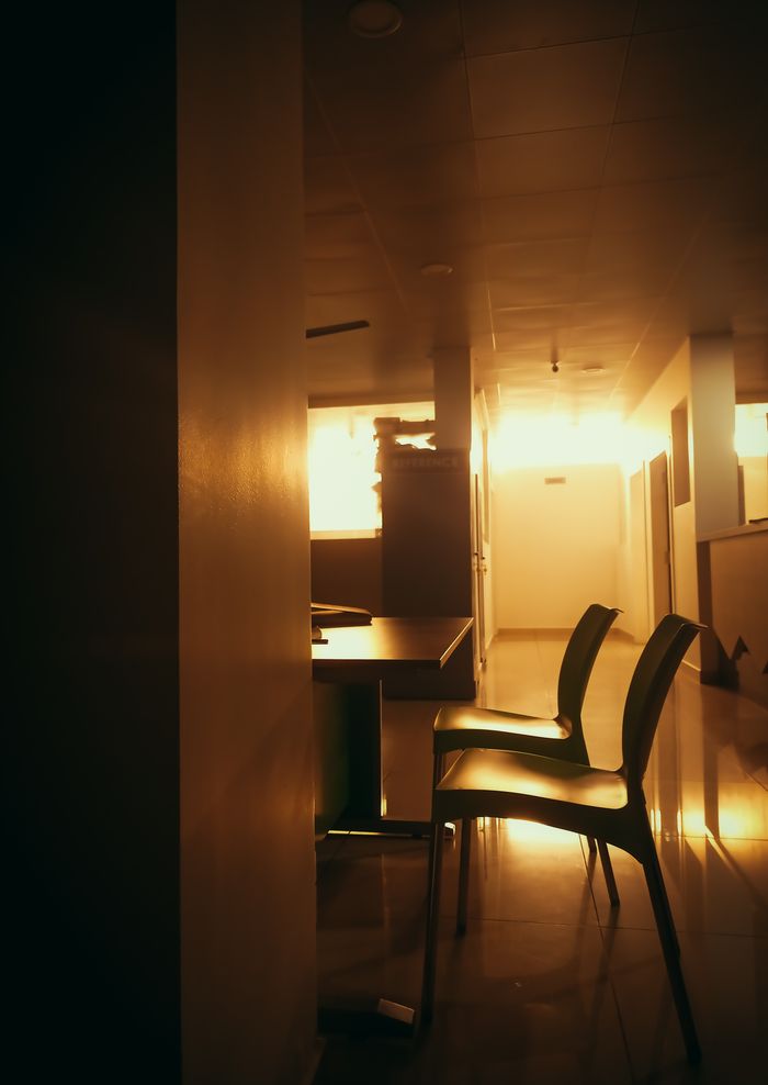 Sunlit modern interior with warm tones and sleek chairs, creating a cozy atmosphere.