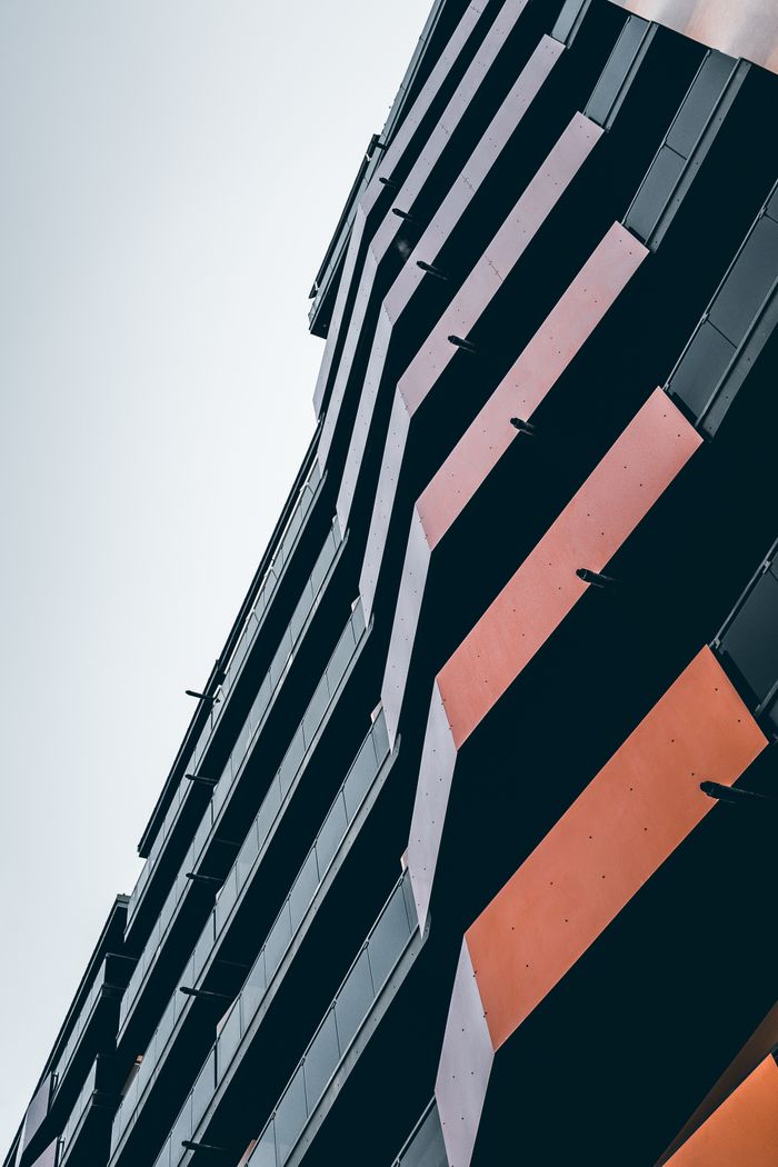 A contemporary urban building showcasing a unique angular facade design, emphasizing modern architecture.